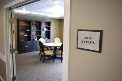 Arts and crafts room with a table and chairs