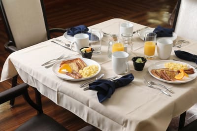 Beautifully set dining table with breakfast plates