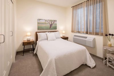 Cozy private room with bed and decorative artwork