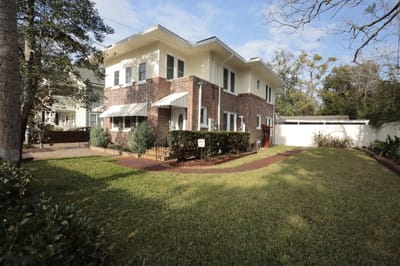 Exterior view of the facility with lawn and garden
