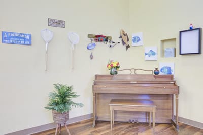 Decorative corner with piano and fishing theme decor