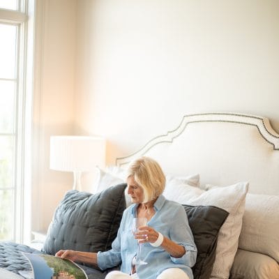 Woman reading in a well-lit bedroom