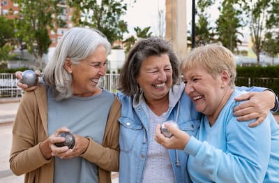 Three smiling women playing in an outdoor setting