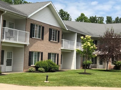Exterior view of the senior living facility with greenery
