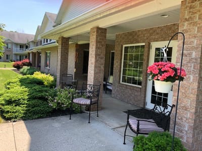 Outdoor porch area with seating and flowers
