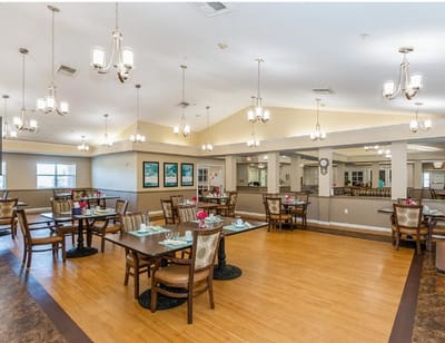 Bright dining room with tables set for a meal