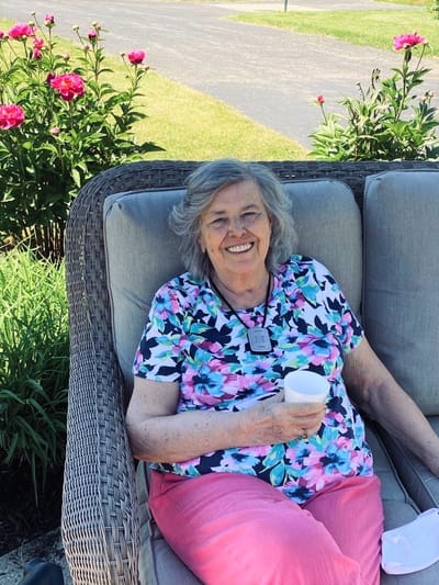 Resident enjoying time outdoors amongst flowers