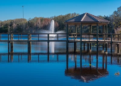 Outdoor wooden gazebo by a tranquil water feature