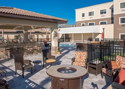 Outdoor patio area with seating and pool view