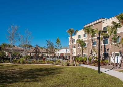 Exterior view of Inspired Living facility with landscaping