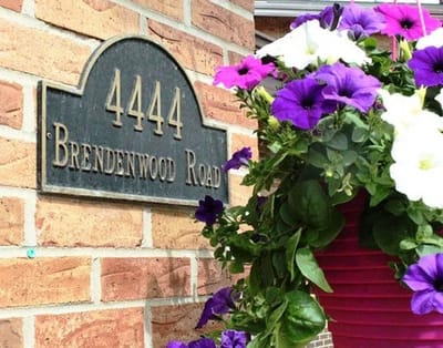Exterior view of the facility sign with flowers