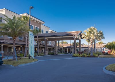 Entrance of Inspired Living at Lakewood Ranch with palm trees