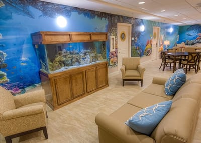 Common area with colorful underwater mural and aquarium