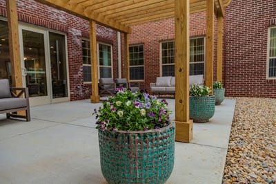 Potted flowers on a covered patio with seating