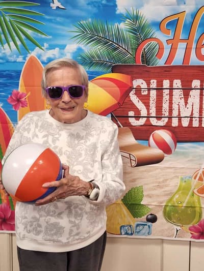 Resident enjoying summer activities with a beach ball