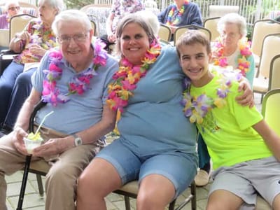 Residents and staff celebrating together with leis