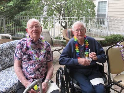 Residents wearing leis and enjoying an outdoor space