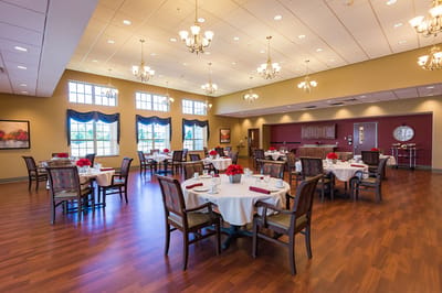 Elegant dining room with tables set for dining