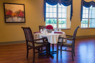 Dining table set for a meal in a bright dining room