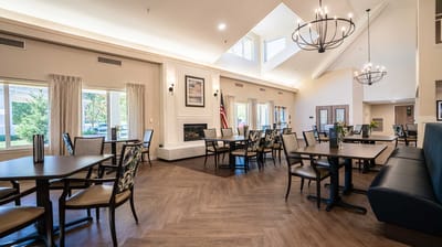 Bright dining room with seating and large windows