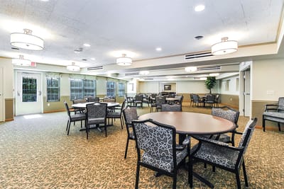 Bright common area with round tables and chairs