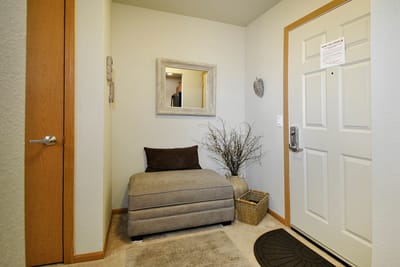 Cozy interior entrance with a mirror and seating area
