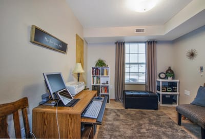 Cozy interior of a resident room with desk and bookshelves