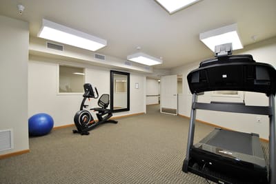 Exercise room with equipment and natural light