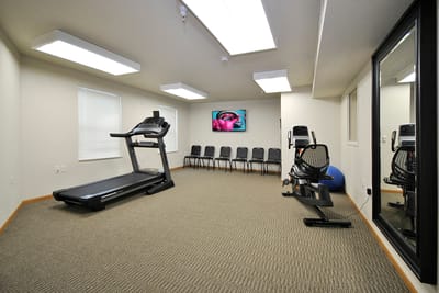 Fitness room with exercise equipment and seating