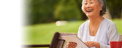 Senior woman using a tablet in a garden