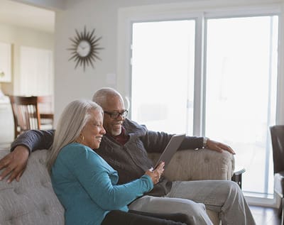 Two residents enjoying time together on a couch