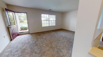 Bright, empty interior space with beige walls and window