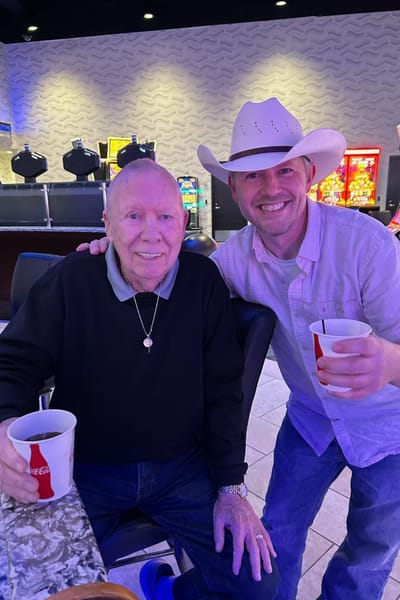 Two residents enjoying drinks at a social event