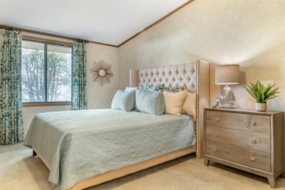 Cozy bedroom with a neatly made bed and natural light