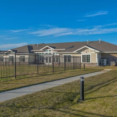 Exterior view of the facility with a fence and walkway