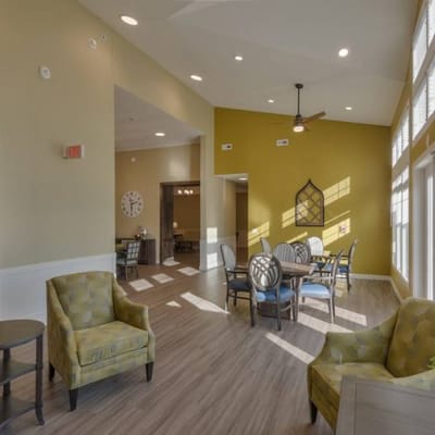 Bright common area with seating and dining tables
