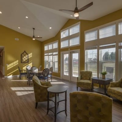Bright common area with seating and large windows