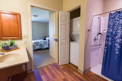 Interior view of a resident's private room and bathroom