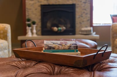 Close-up of a decorative tray with books in a common area