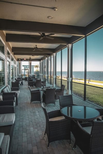 Covered patio area with seating overlooking the waterfront