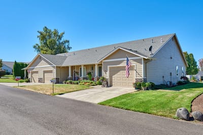 Exterior view of a senior living building with garden.