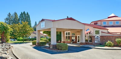 Building entrance with landscaping and American flag
