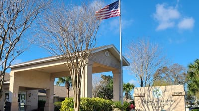 Front entrance of Magnolia Gardens Assisted Living with American flag