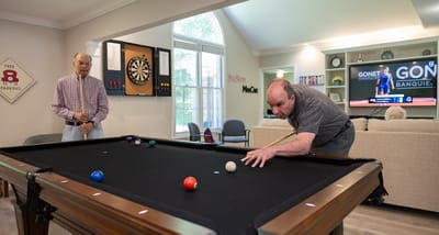 Residents playing billiards in a common area