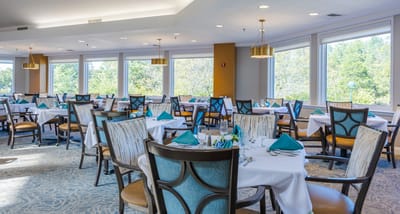 Bright dining room with tables set for meals
