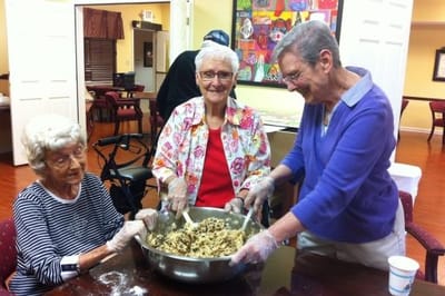 Residents baking together in a bright activity room