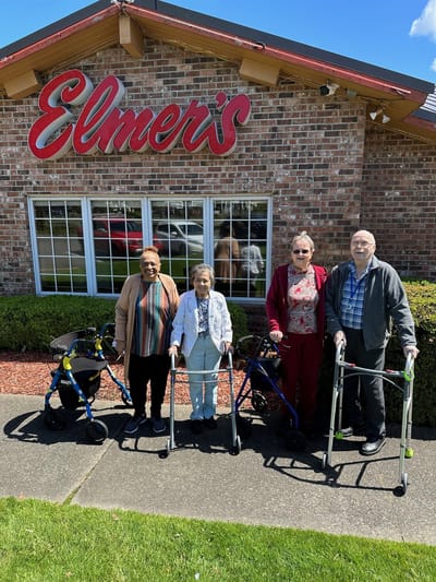 Residents and staff outside the facility entrance