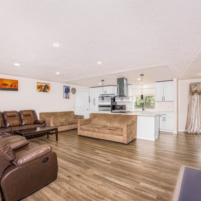 Bright common area with seating and kitchen view