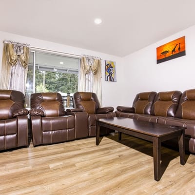 Cozy lounge area with leather recliners and artwork