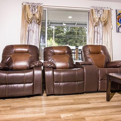 Cozy seating area with recliner chairs and large windows
